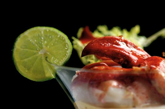 Image of lobster cocktail with sauce and lime garnish