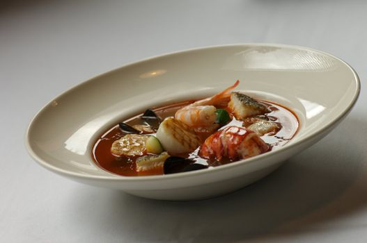 Image of stew consisting of lobster, shellfish, and other seafood