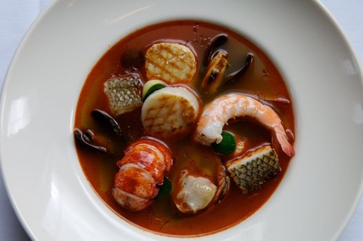 Image of stew consisting of lobster, shellfish, and other seafood