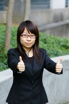 Asian businesswoman with thumbs up