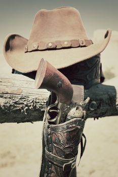 cowboy gun and hat outdoor in a ranch