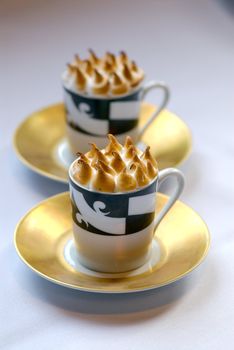 Image of mugs of cappaccino on saucers