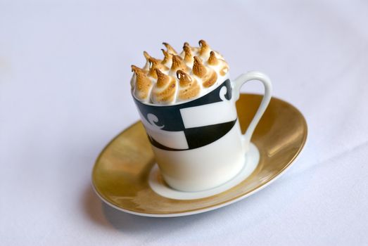 Image of mugs of cappaccino on saucers