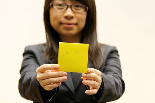 Businesswoman with deal memo paper on hands