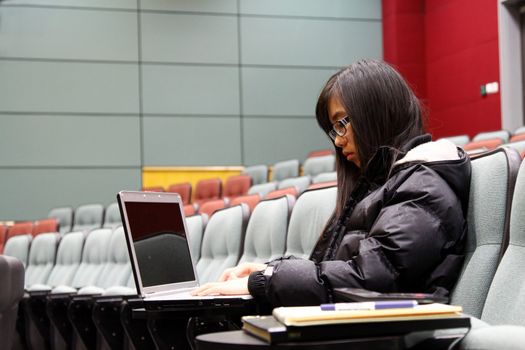 Asian student using laptop to study