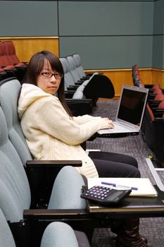 Asian university student using laptop and studying