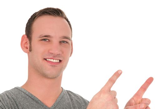 Attractive young man pointing upwards isolated on white