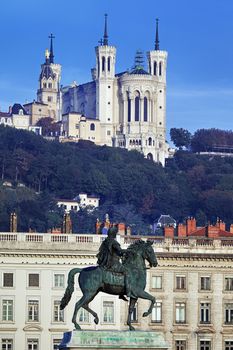 famous statue and Fourviere basilic on a background