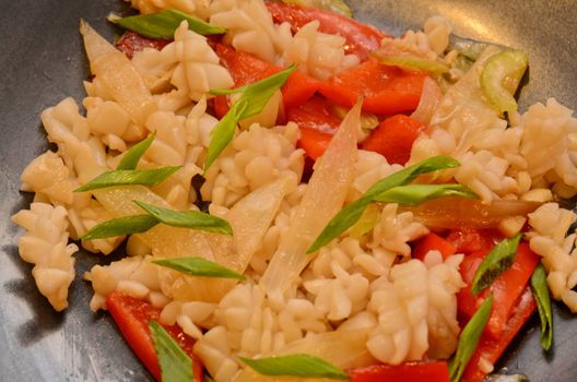 closeup dish of calamari with celery at black plate
