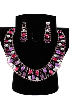 a necklace with pendants and earrings on a white background