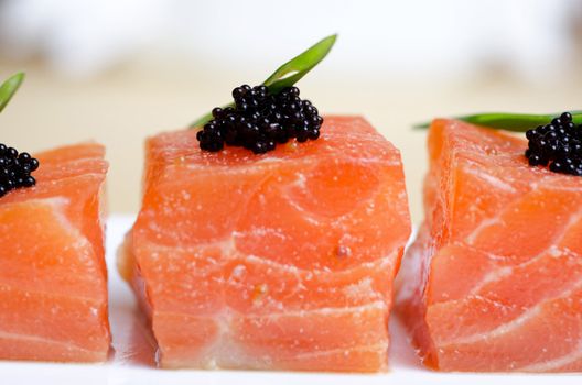 Salmon Slices with black tobiko caviar and greens