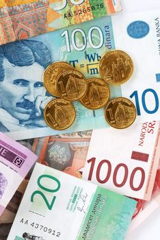 various serbian dinars coins over paper banknotes