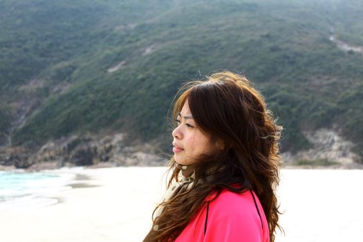 Asian woman thinking on the beach