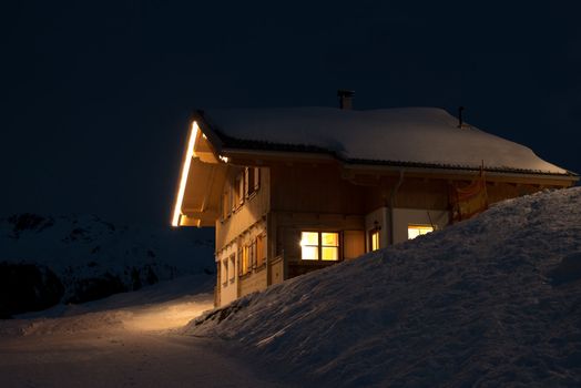 Beautiful skiing hut at night in a valley of Montafon, photo taken from public skiing piste