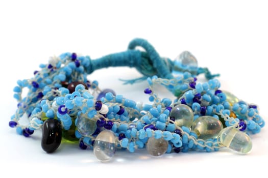 handmade bracelet of glass beads from India on white background