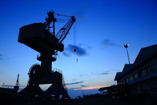 Cranes in dockyard  at sunset