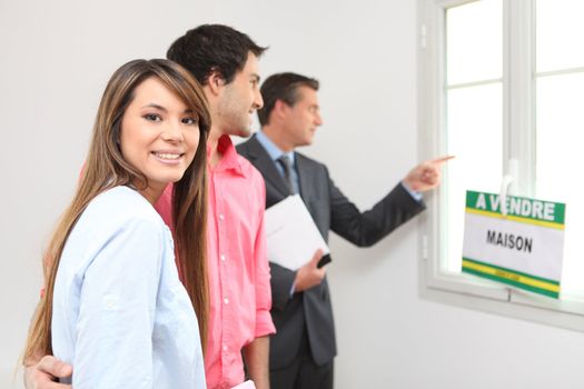 Excited young couple viewing a property