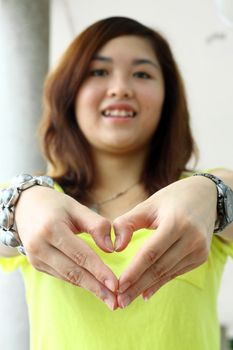 Asian woman making a heart