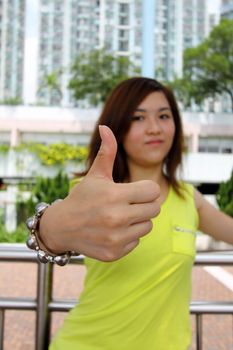 Asian woman with thumbs up