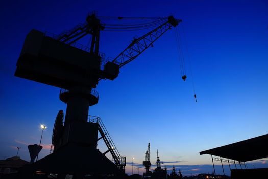 Cranes in dockyard  at sunset