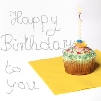 Cupcake with a candle, and text happy birthday to you - Copy Space