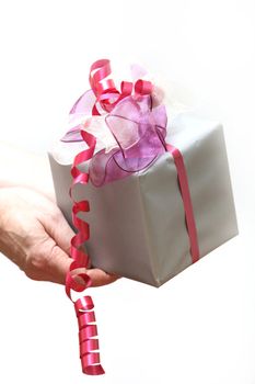 A gift will be presented with ribbon - white background