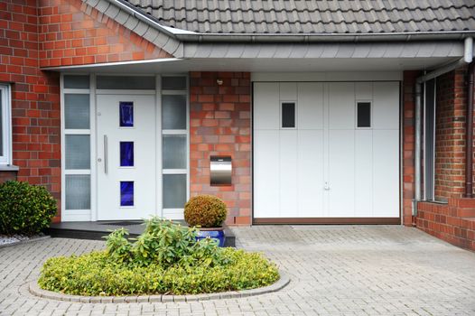 Modern entry door to the house with front yard