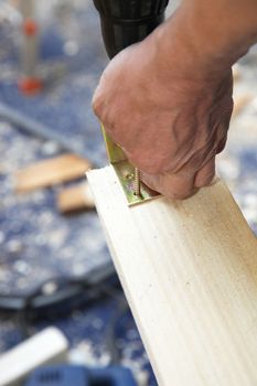 Craftsmen in wood screwed elbow to - Close up