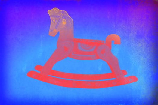Child colorful background, red rocking horse on blue paper