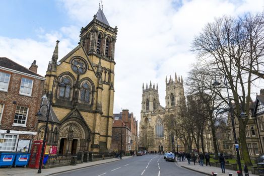 YORK, UK - MARCH 29: Street view from Dumcombe Place showing Saint Wilfrid's Church and York Minster at the back. March 29, 2013 in York.