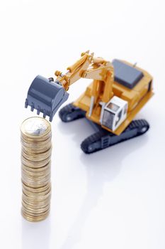 making euro money coins with digger isolated on white background 