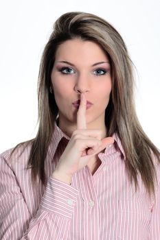 Portrait of beautiful young woman with silence gesture over white background 