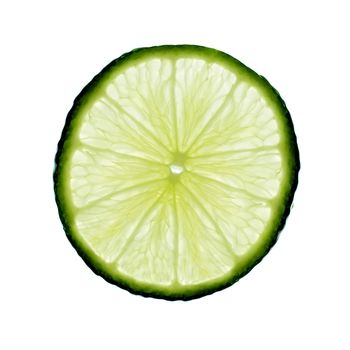 Slice of lime, backlit and isolated on white.