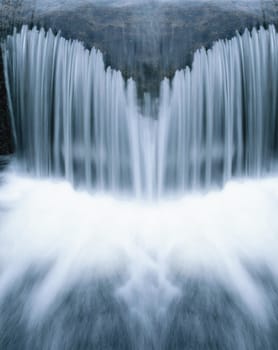 Beautiful cascading waterfall over natural rocks