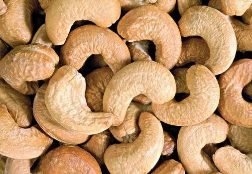 Unshelled roasted cashew nuts isolated on white, food background