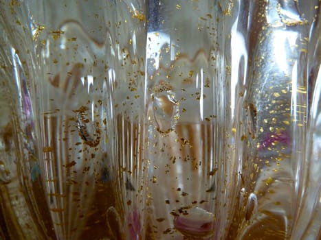 reflections in glass object with gold flecks