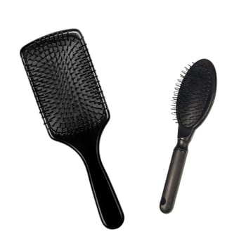 two hairbrushes , comb on bright background