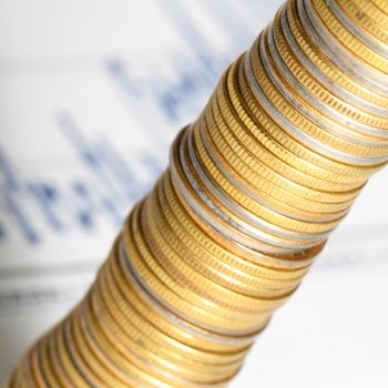 coins and financial graph on background