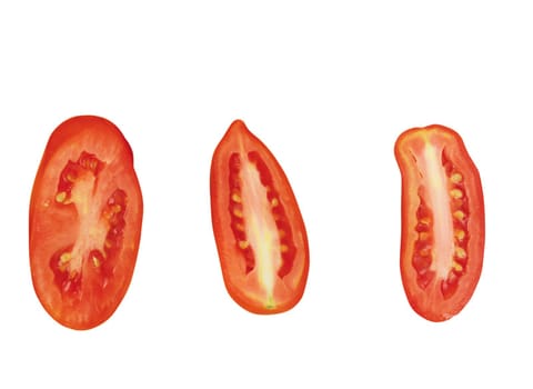 close up of slices of ripen tomato piled on white background