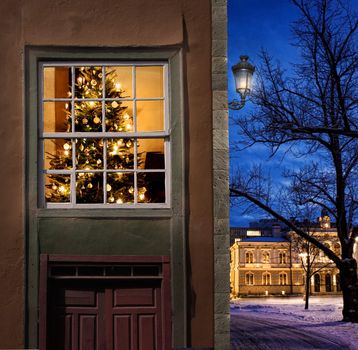 Christmas tree home seen from outside in a snowy little winter town