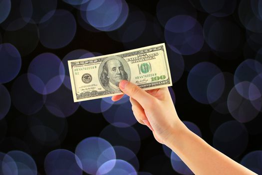 abstract of bokeh background with female hand holding money dollars