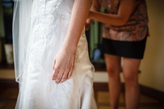 Bride getting dressed on her wedding day