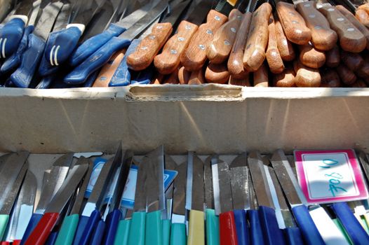 Variety of cheap knives for sale on street market.