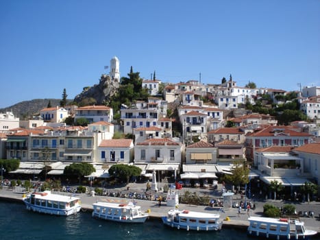 Heart of Poros town with Clock Tower on the hill                           