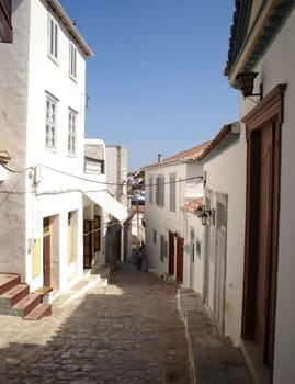 Street of a greek town run down to sea                               