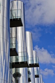 Futuristic building with balcony and deep blue sky.