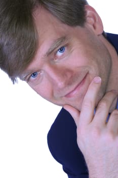 Handsome businessman with slight smile, posing chin on hand