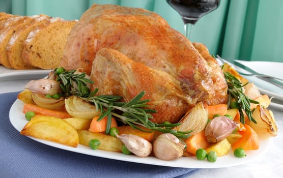 Baked chicken with vegetables and whole rosemary