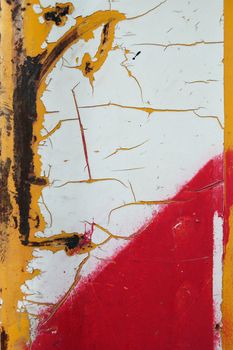 Cracked paint on rusty industrial metal texture.