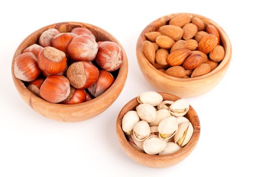 almonds, pistachio and hazelnut in the wooden bowls